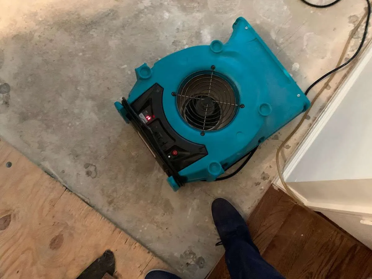 Air mover drying subfloor during Commercial Water Damage Restoration in North Kingstown
